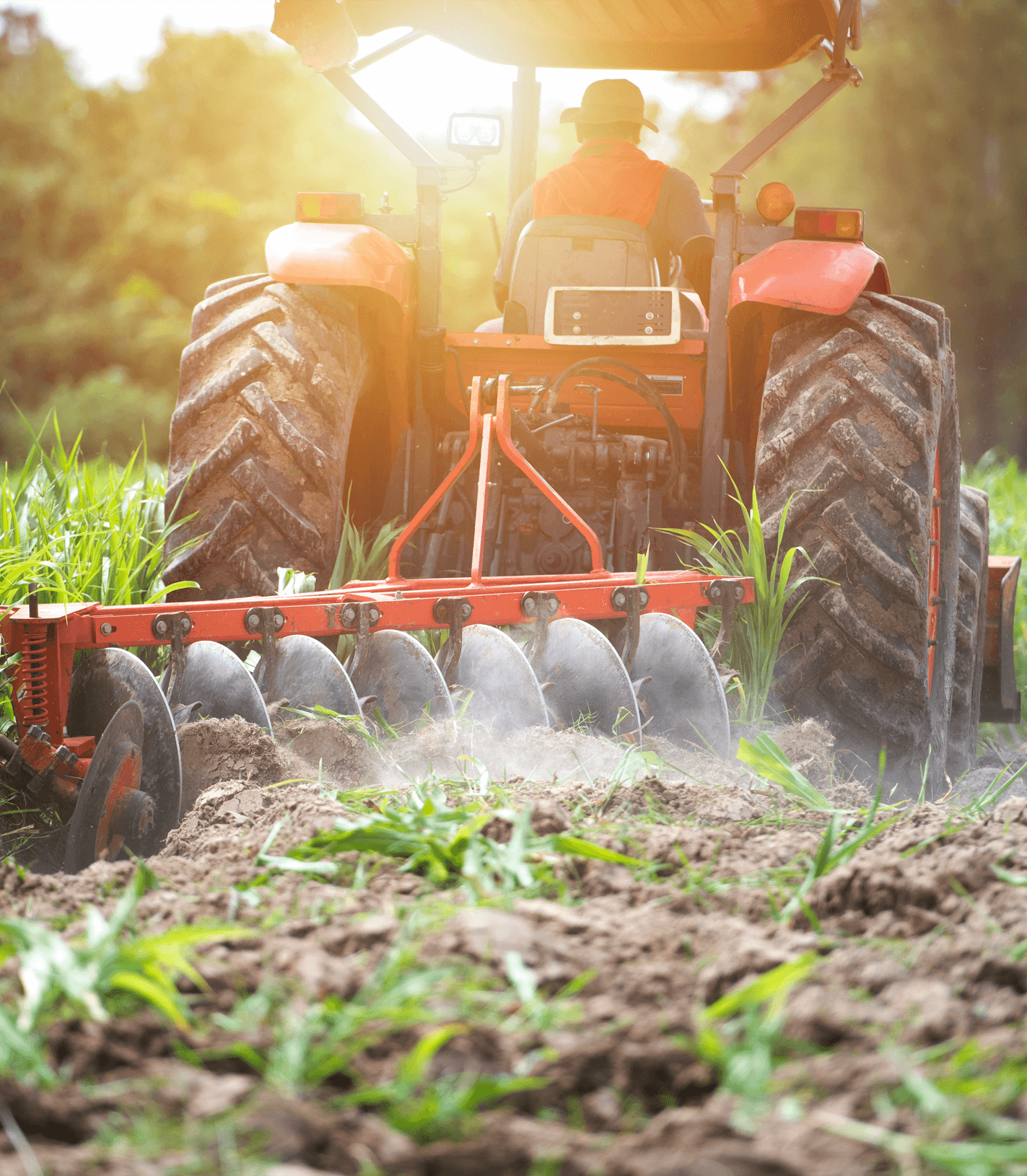 A tractor ploughs a grassy field.