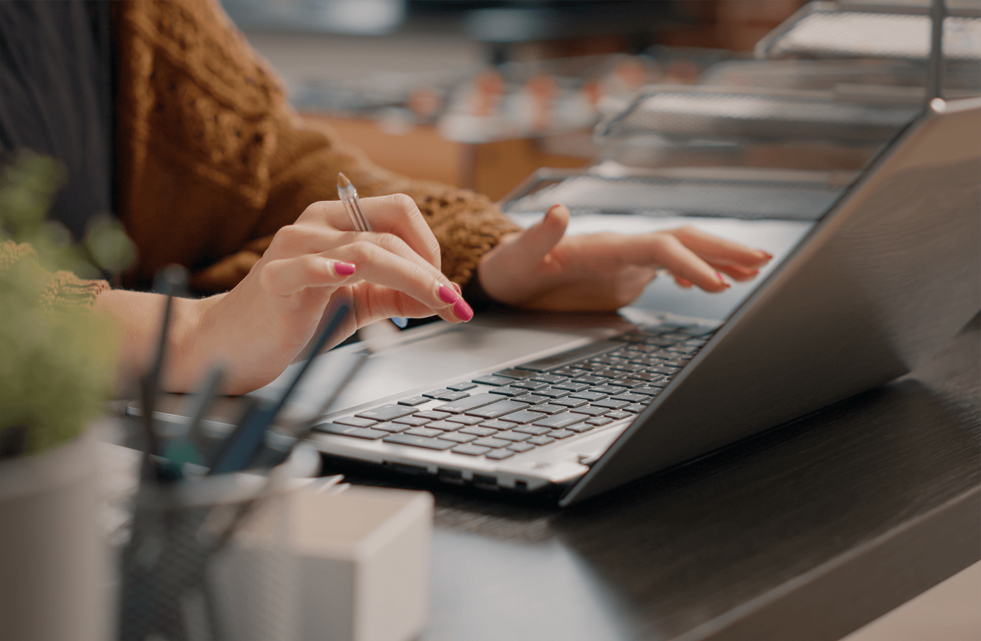 A close up of a woman working at a laptop.