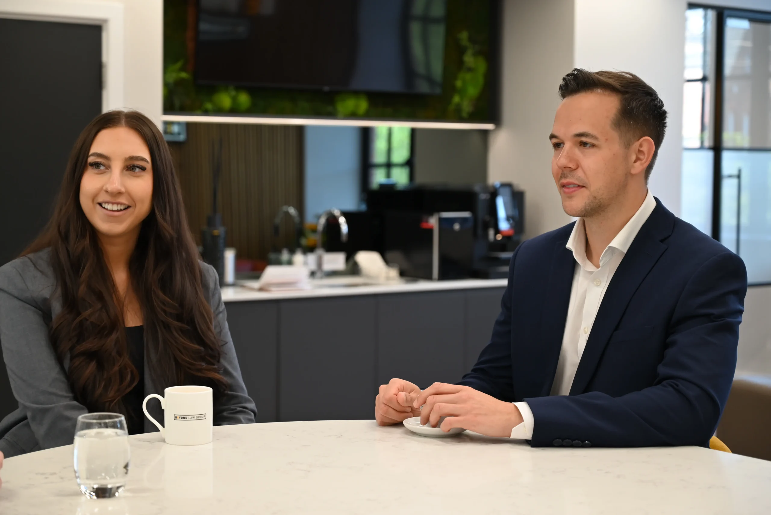 Russell Kaminski sits in the office with a colleague.