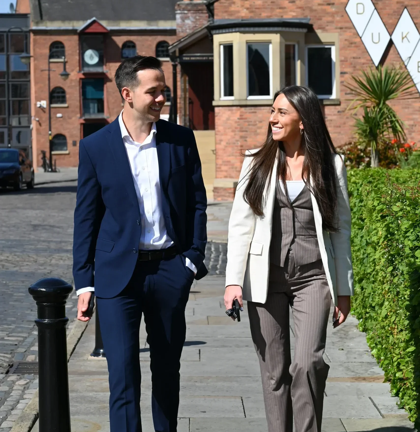Lucy Cresswell and Russell Kaminski walk together outside.