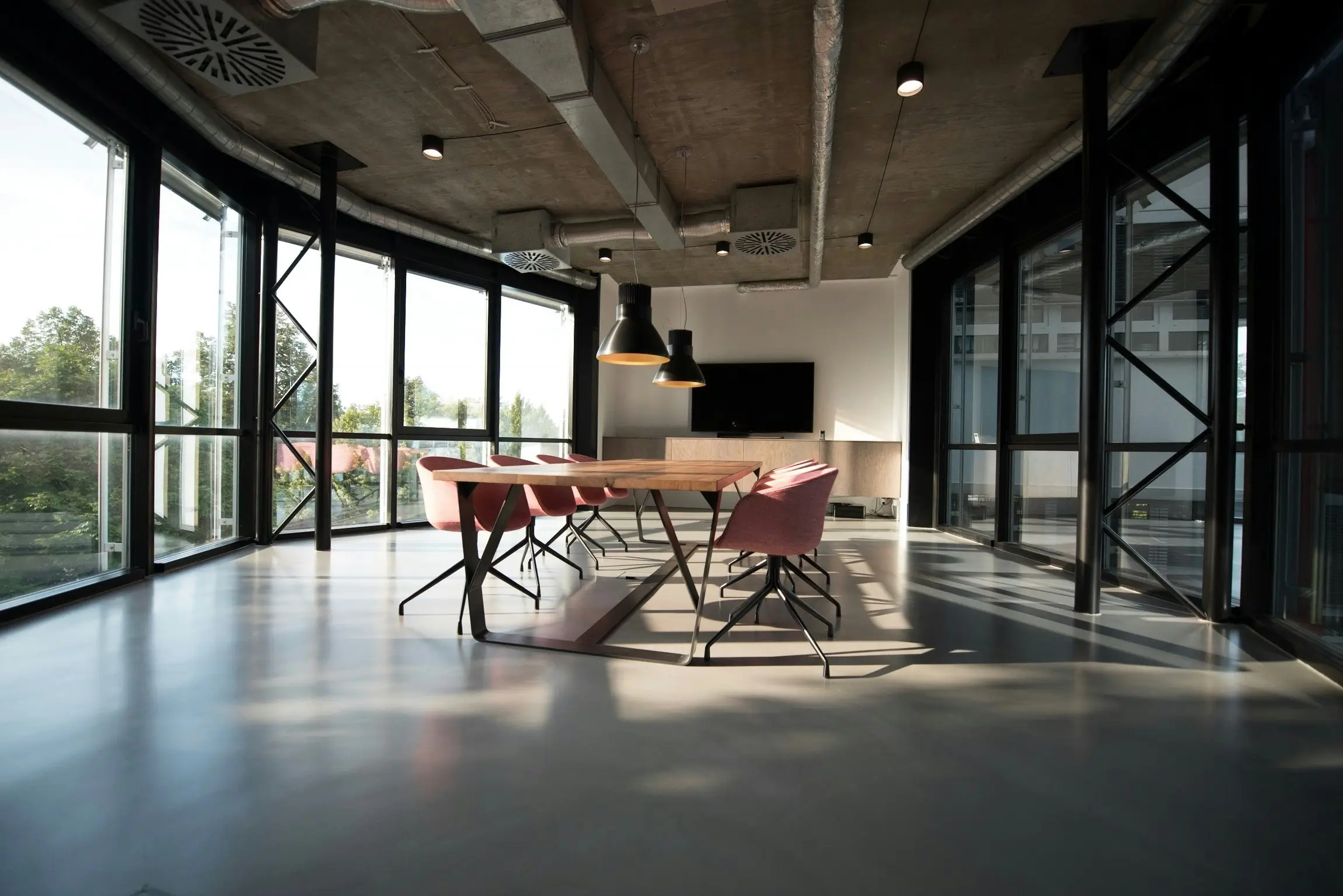 An empty modern industrial style office board room.