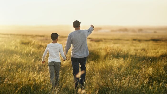Father and son in field